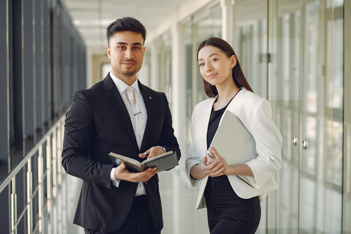 Smiling coworkers standing in modern office